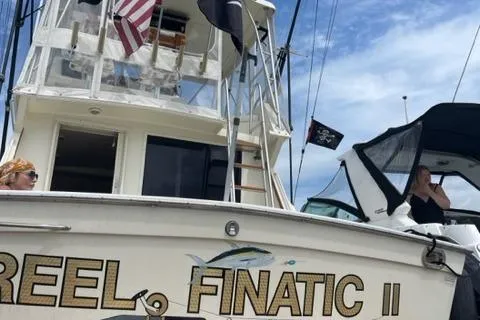  Yacht Photos Pics 1989 Viking 41 Sportfish Convertible with flags and people on board.