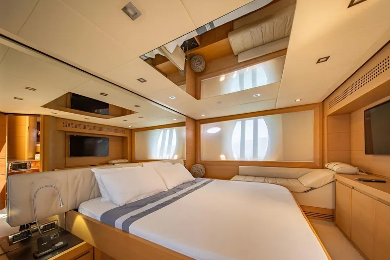 Freedom 2 Yacht Photos Pics Luxurious bedroom interior of 2010 Pershing 72 yacht with modern design and elegant furnishings.