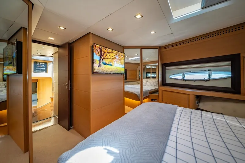 Freedom 2 Yacht Photos Pics Luxurious interior of 2010 Pershing 72 yacht, featuring modern bedroom and elegant wood finishes.