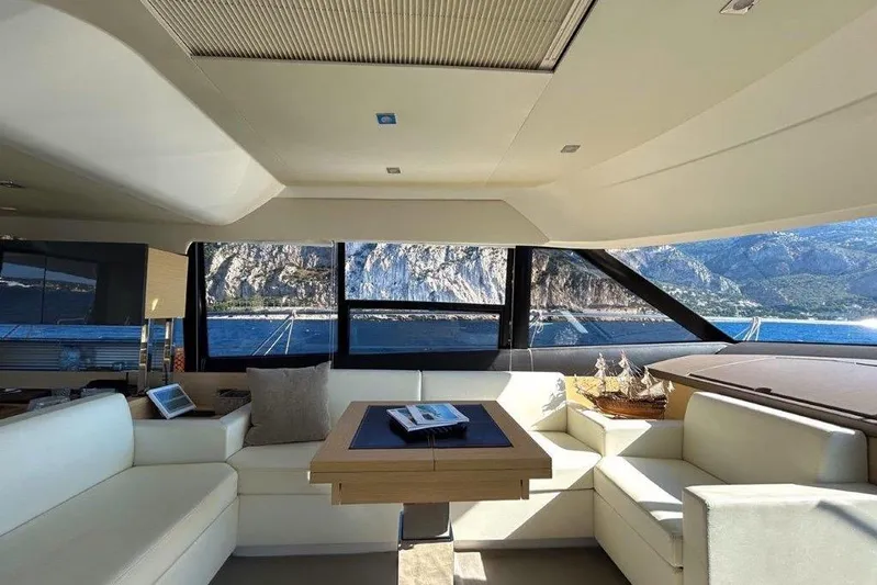  Yacht Photos Pics Luxurious interior of 2015 Prestige 550 yacht with scenic ocean view through large windows.