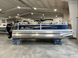2025 Sun Tracker Bass Buggy® 16 XL Select pontoon boat in a showroom.