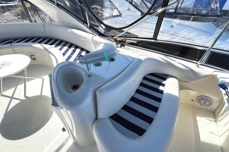 Old Hickory Yacht Photos Pics 2008 Meridian 391 Sedan interior with striped seating, table, and sink.