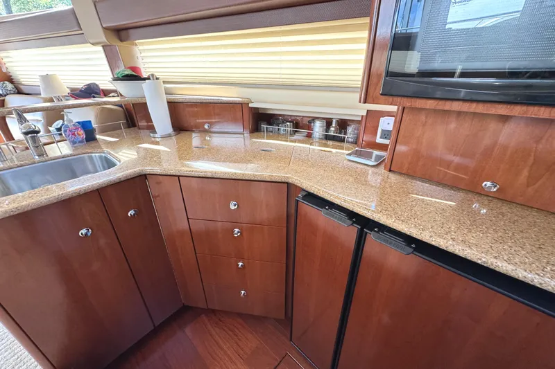 Old Hickory Yacht Photos Pics Luxurious kitchen interior of 2008 Meridian 391 Sedan yacht with wood cabinetry and granite countertops.