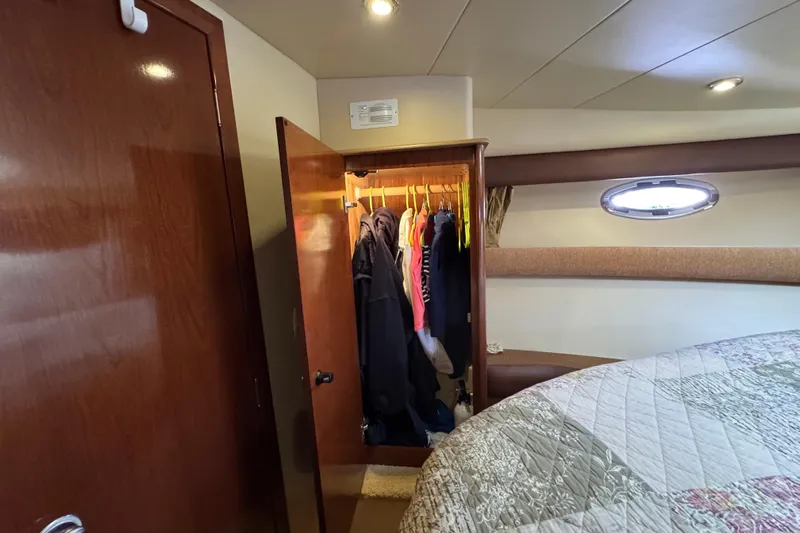 Old Hickory Yacht Photos Pics Interior of 2008 Meridian 391 Sedan with open closet and cozy bedding.