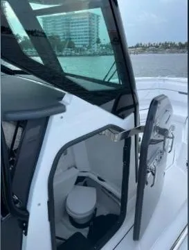  Yacht Photos Pics 2022 Blackfin 272 CC boat with open cabin door showing interior.