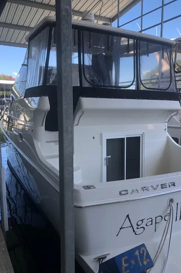 Agape III Yacht Photos Pics 2005 Carver 41 Cockpit Motor Yacht docked in a marina.