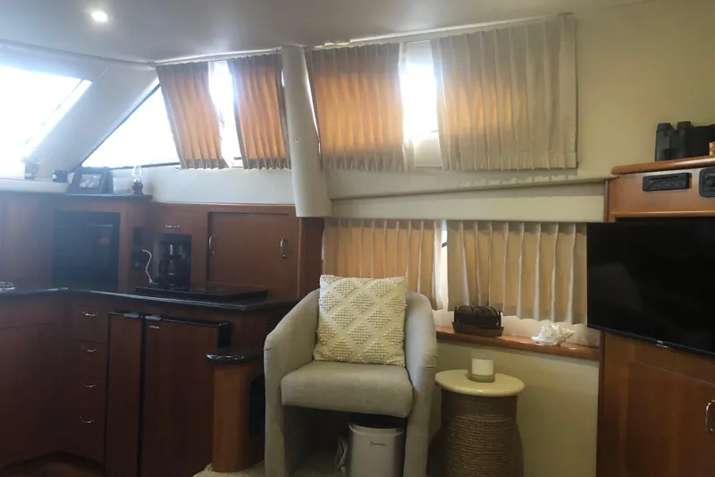 Agape III Yacht Photos Pics Interior of 2005 Carver 41 Cockpit Motor Yacht with kitchen and seating area.