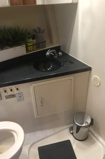 Agape III Yacht Photos Pics 2005 Carver 41 Cockpit Motor Yacht bathroom with black countertop and sink.