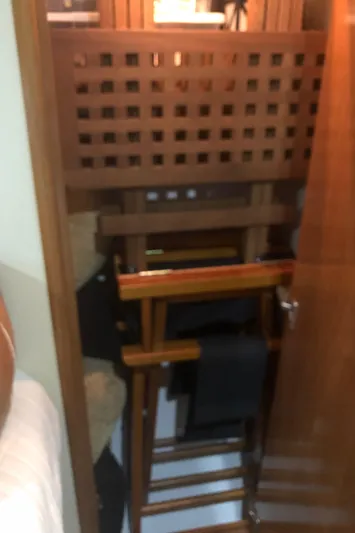 Agape III Yacht Photos Pics Storage area inside 2005 Carver 41 Cockpit Motor Yacht with wooden furniture.