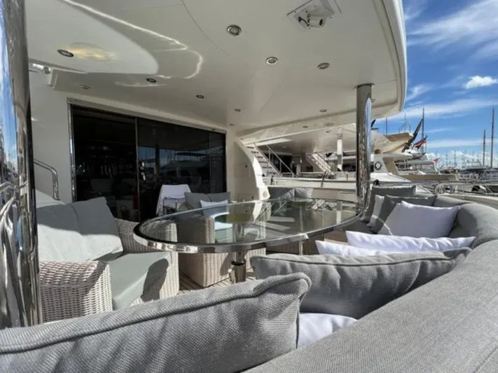  Yacht Photos Pics Luxury yacht deck with elegant seating, glass table, and marina view. Horizon Elegance 90 Mega, 2008.