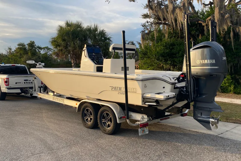  Yacht Photos Pics 2020 Pathfinder 2500 Hybrid boat on trailer with Yamaha engine, parked outdoors.