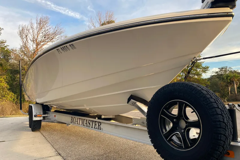  Yacht Photos Pics 2020 Pathfinder 2500 Hybrid boat on Boatmaster trailer, parked outdoors.