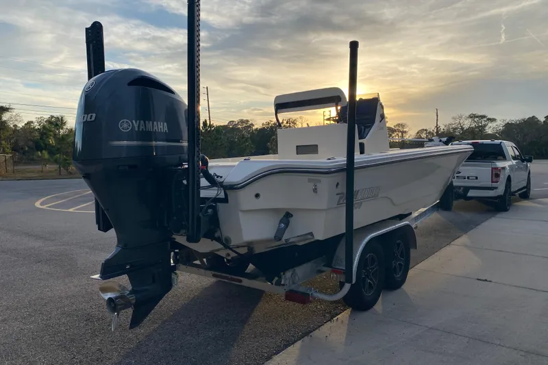 Yacht Photos Pics 2020 Pathfinder 2500 Hybrid boat with Yamaha engine on trailer at sunset.