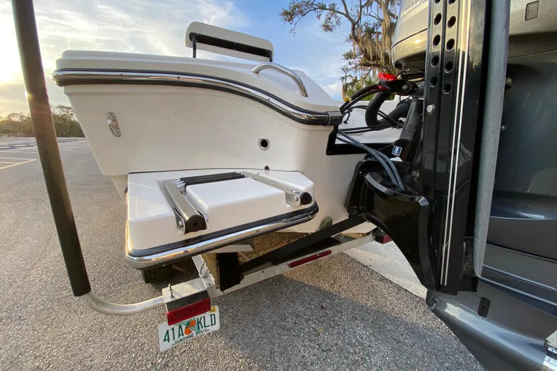  Yacht Photos Pics Rear view of a 2020 Pathfinder 2500 Hybrid boat with ladder and motor.