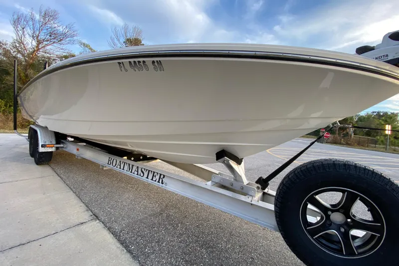  Yacht Photos Pics 2020 Pathfinder 2500 Hybrid boat on Boatmaster trailer, parked on pavement.