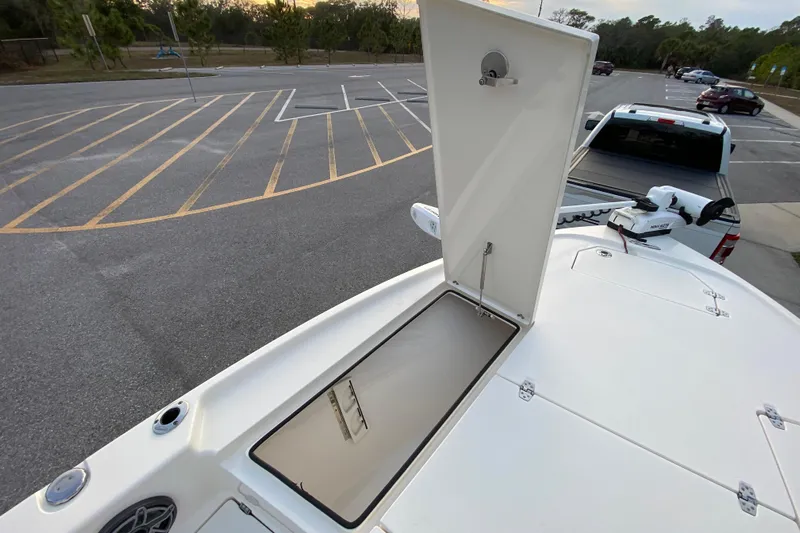  Yacht Photos Pics 2020 Pathfinder 2500 Hybrid boat with open storage compartment in a parking lot.