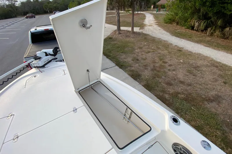  Yacht Photos Pics Open storage compartment on 2020 Pathfinder 2500 Hybrid boat, parked near a trail.