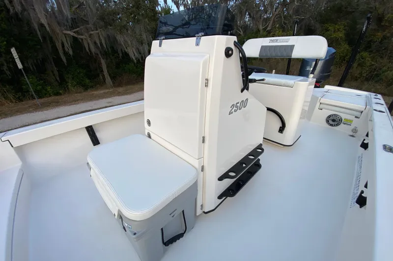  Yacht Photos Pics 2020 Pathfinder 2500 Hybrid boat interior with seating and console, set in a natural environment.