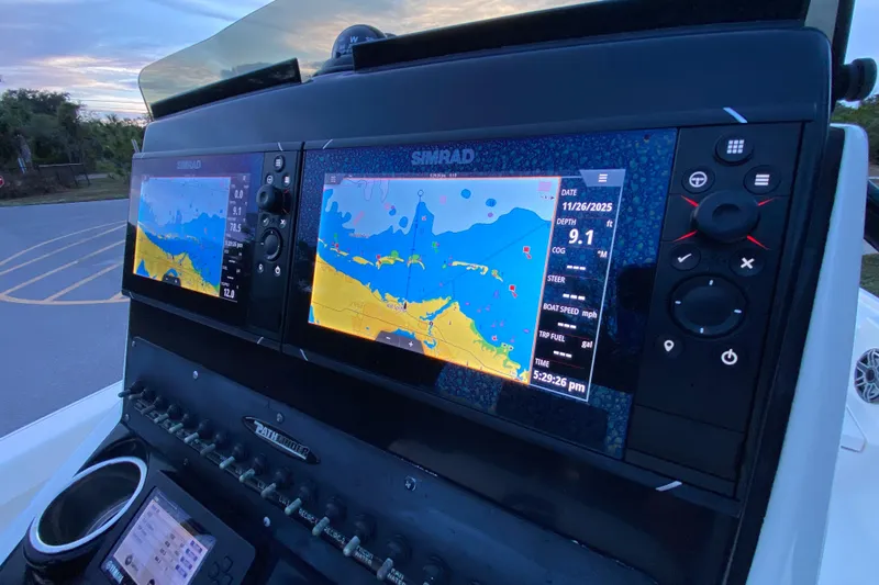  Yacht Photos Pics Simrad navigation system on 2020 Pathfinder 2500 Hybrid boat dashboard at sunset.