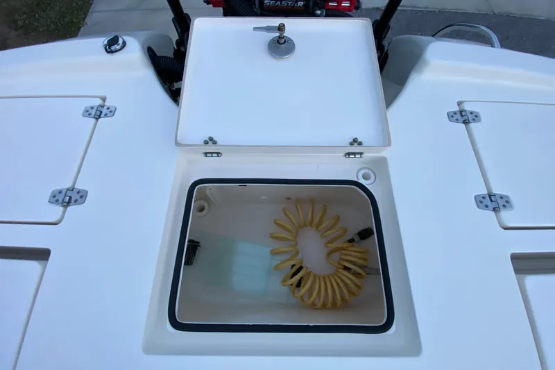  Yacht Photos Pics 2020 Pathfinder 2500 Hybrid boat storage compartment with coiled hose.