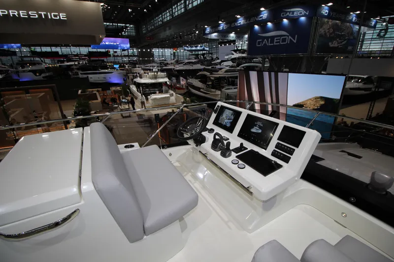  Yacht Photos Pics Prestige M48 yacht cockpit at a boat show, showcasing modern navigation technology, 2025 model.