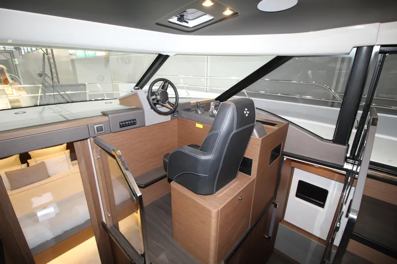  Yacht Photos Pics Interior of 2025 Prestige M48 yacht, featuring modern helm and luxurious seating.