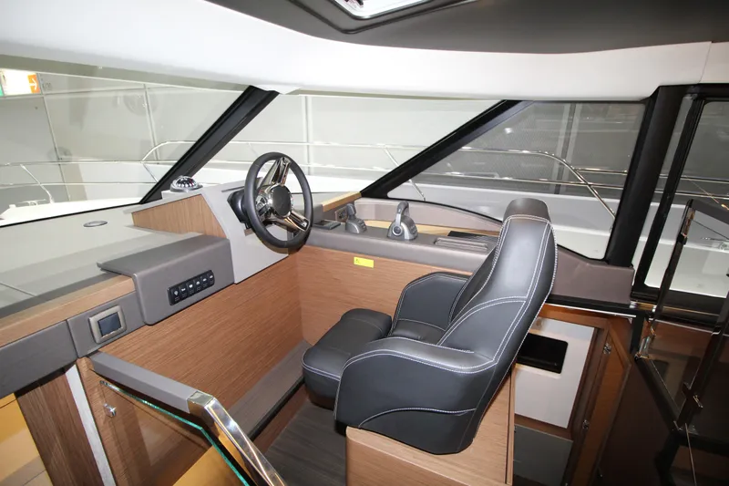  Yacht Photos Pics Interior of 2025 Prestige M48 yacht with modern helm and leather captain's chair.