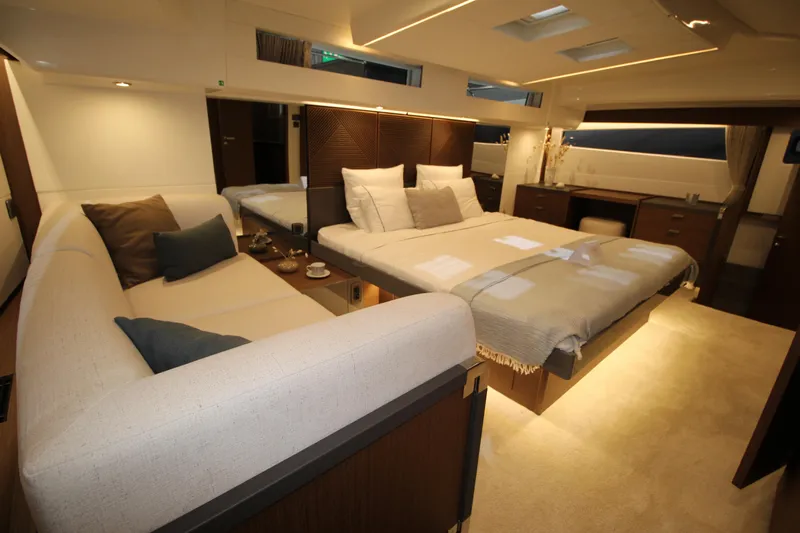  Yacht Photos Pics Luxurious interior of 2025 Prestige M48 yacht with elegant bedding and seating area.