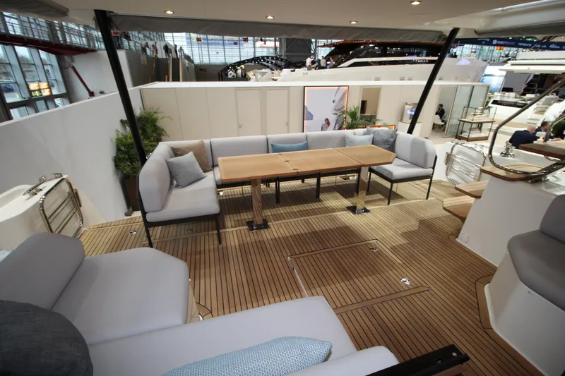  Yacht Photos Pics Luxurious seating area on 2025 Prestige M48 yacht with wooden deck and modern furnishings.