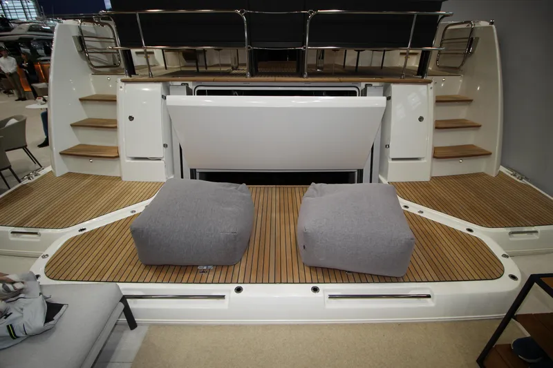  Yacht Photos Pics 2025 Prestige M48 yacht with spacious teak deck and cushioned seating area.