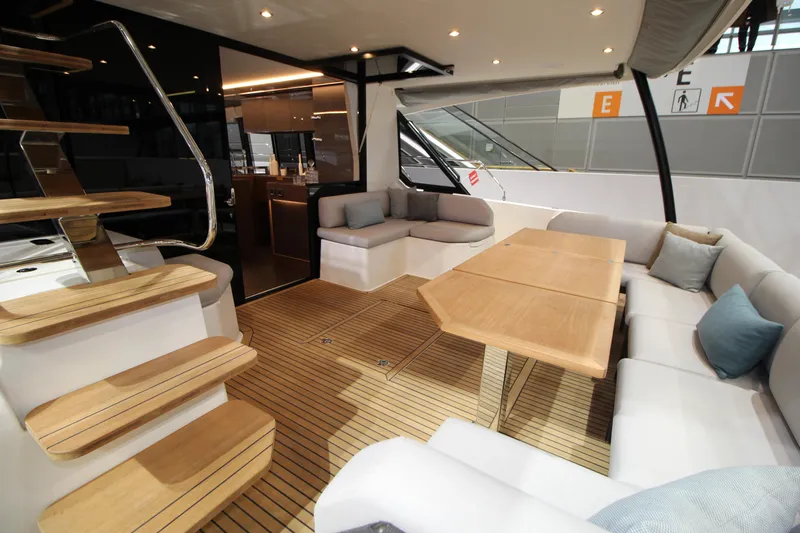  Yacht Photos Pics Luxurious 2025 Prestige M48 yacht interior with elegant seating and wooden accents.