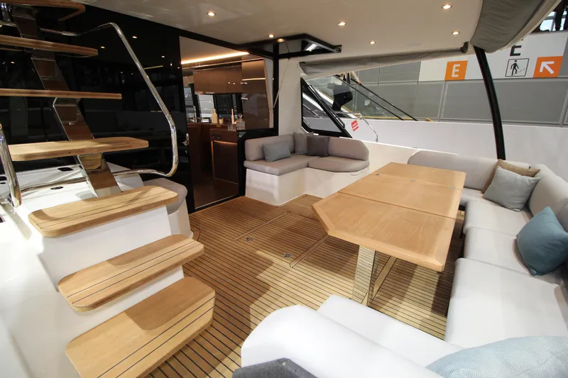  Yacht Photos Pics Luxurious 2025 Prestige M48 yacht interior with elegant seating and wooden table.