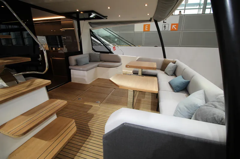  Yacht Photos Pics Luxurious interior of 2025 Prestige M48 yacht with elegant seating and wooden flooring.