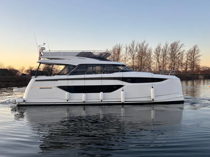  Yacht Photos Pics 2025 Prestige M48 yacht on calm water at sunset.