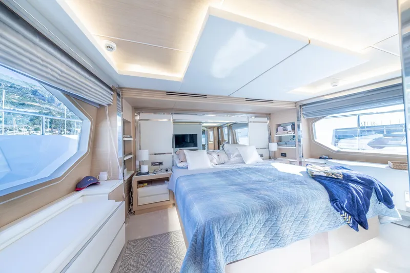  Yacht Photos Pics Luxurious bedroom interior of 2013 Benetti Delfino 93 yacht, featuring elegant design and large windows.