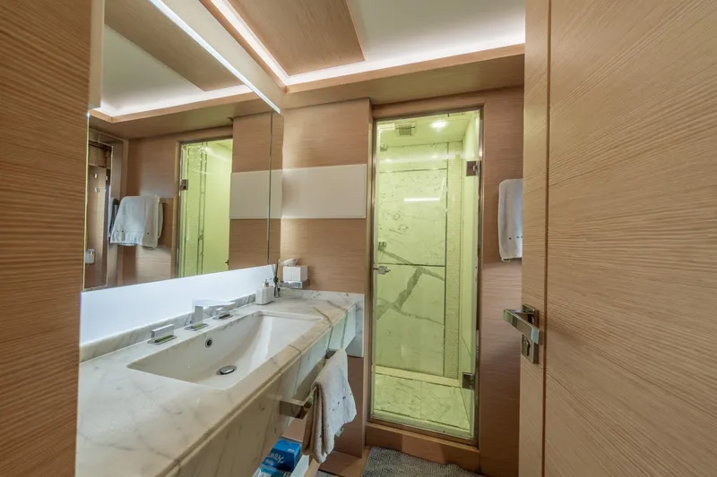  Yacht Photos Pics Luxurious bathroom on 2013 Benetti Delfino 93 yacht with marble sink and glass shower.