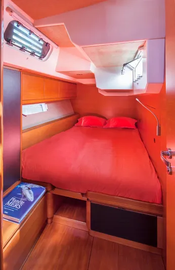 Canteloup VIII Yacht Photos Pics Cozy cabin interior of 2014 Ice Yachts Ice 62 with red bedding and wooden finish.