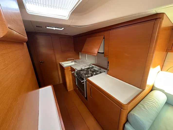 Canteloup VIII Yacht Photos Pics Luxurious kitchen interior of 2014 Ice Yachts Ice 62 sailboat with wooden cabinetry.