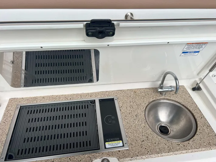 The Good Life Yacht Photos Pics Outdoor kitchenette on 2018 Sea Ray 400 Sundancer with sink and Kenyon grill.