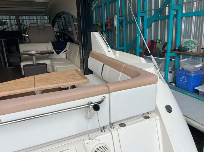 The Good Life Yacht Photos Pics 2018 Sea Ray 400 Sundancer interior with seating and table in a docked position.