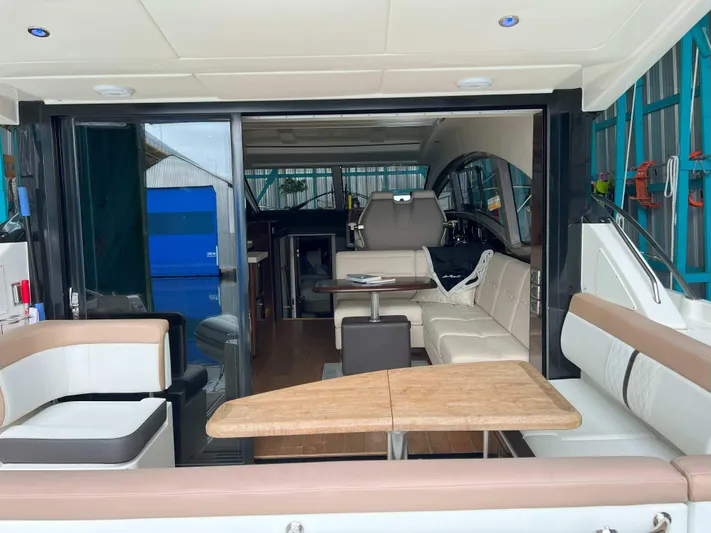 The Good Life Yacht Photos Pics 2018 Sea Ray 400 Sundancer yacht interior with luxurious seating and wooden table.