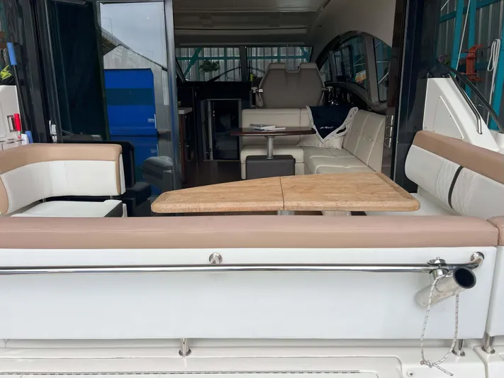 The Good Life Yacht Photos Pics 2018 Sea Ray 400 Sundancer yacht interior with seating and wooden table.