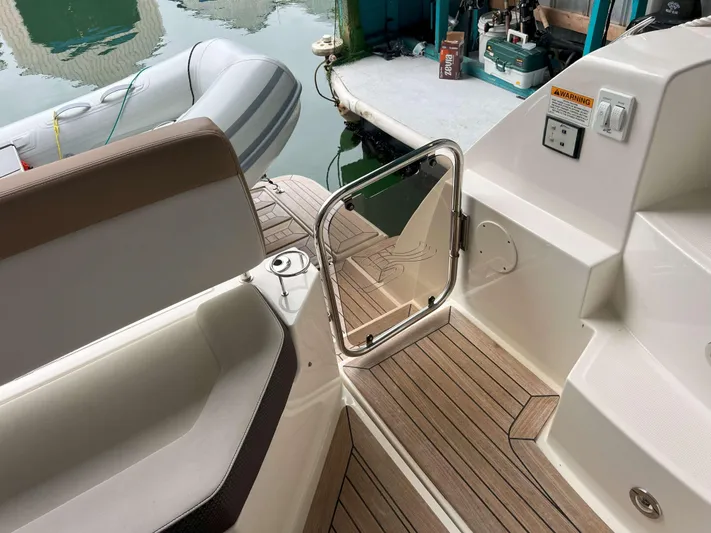 The Good Life Yacht Photos Pics 2018 Sea Ray 400 Sundancer yacht deck with wooden flooring and inflatable boat nearby.