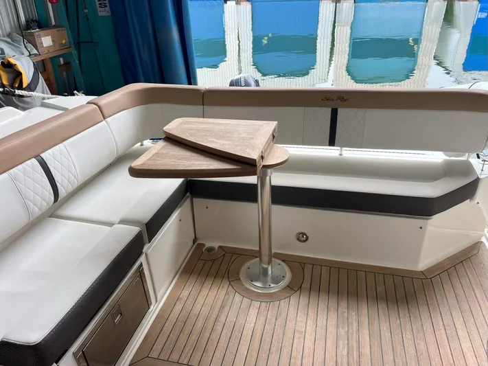 The Good Life Yacht Photos Pics 2018 Sea Ray 400 Sundancer interior with elegant seating and wooden table.
