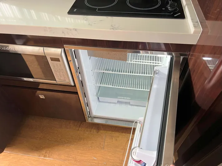 The Good Life Yacht Photos Pics Kitchen area of 2018 Sea Ray 400 Sundancer with open fridge and microwave.