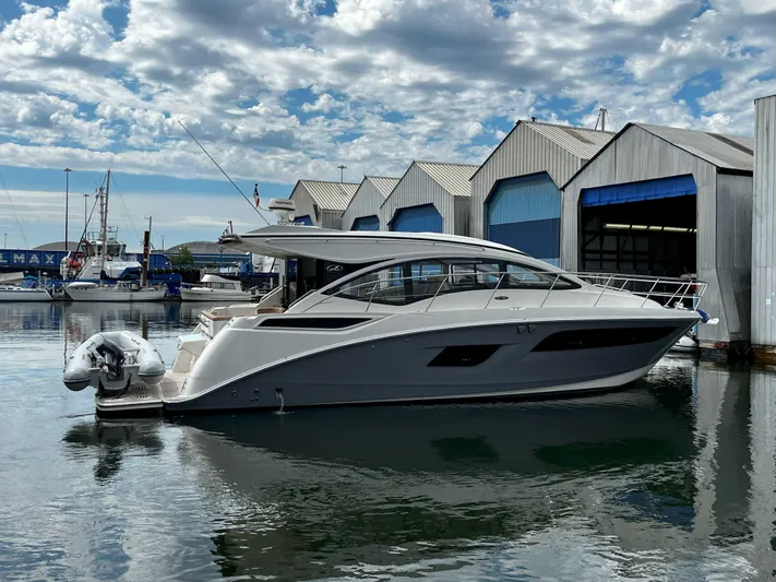 The Good Life Yacht Photos Pics 2018 Sea Ray 400 Sundancer yacht docked at marina under cloudy sky.