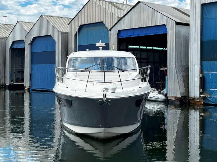 The Good Life Yacht Photos Pics 2018 Sea Ray 400 Sundancer yacht docked at marina with blue boathouses.
