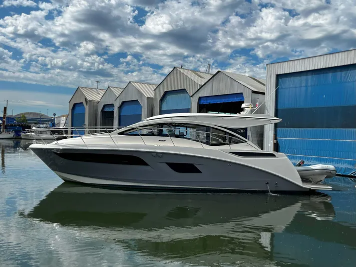 The Good Life Yacht Photos Pics 2018 Sea Ray 400 Sundancer yacht docked near blue boat sheds.