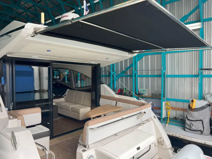 The Good Life Yacht Photos Pics 2018 Sea Ray 400 Sundancer yacht interior with seating and retractable awning in a marina.