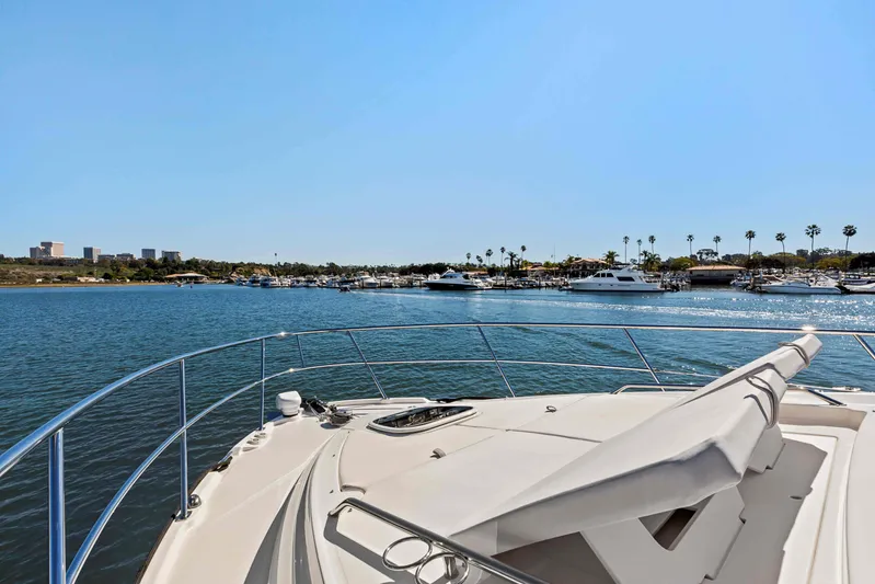 The Good Life Yacht Photos Pics Bow view of 2018 Sea Ray 400 Sundancer yacht in a sunny marina.